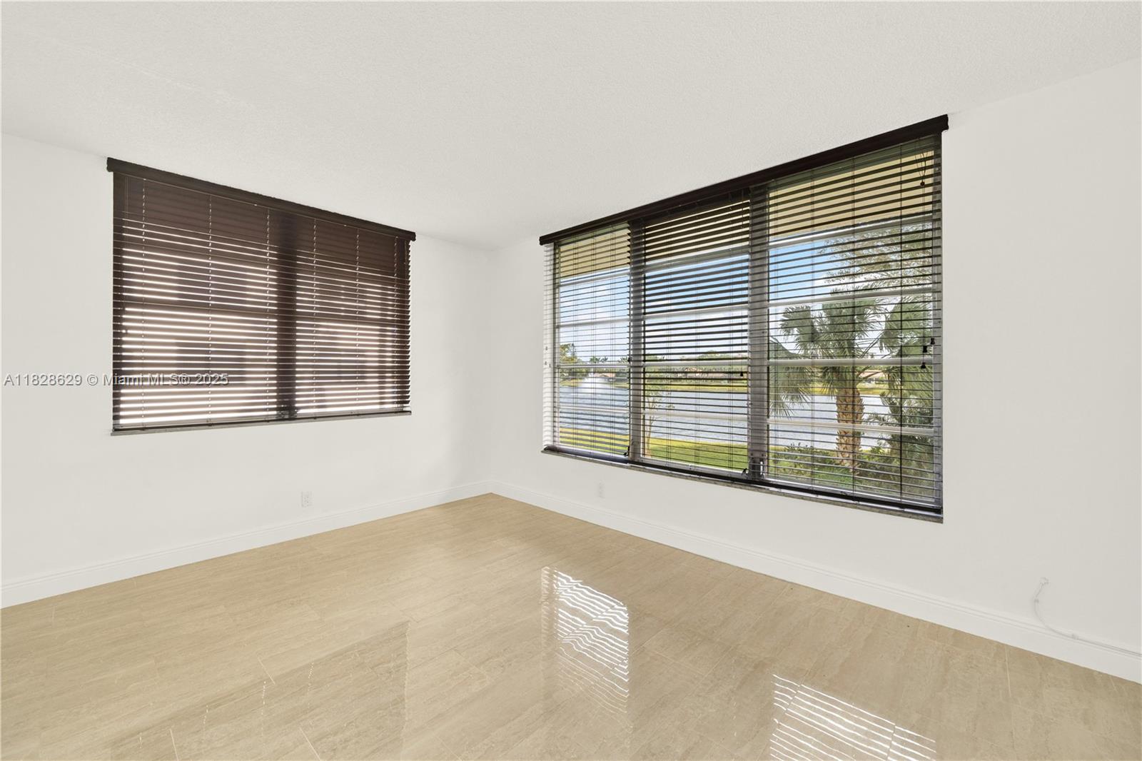 3200 North Course Lane, Unit 216 Pompano Beach, FL 33069 - Photo 16 of 36 a view of an empty room with a window