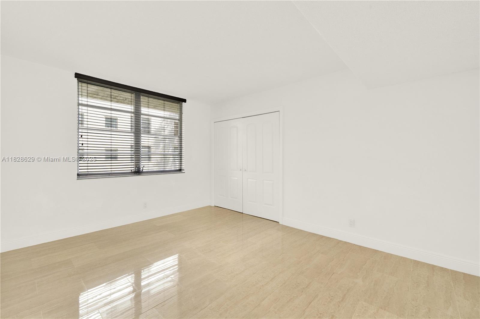 3200 North Course Lane, Unit 216 Pompano Beach, FL 33069 - Photo 19 of 36 an empty room with windows