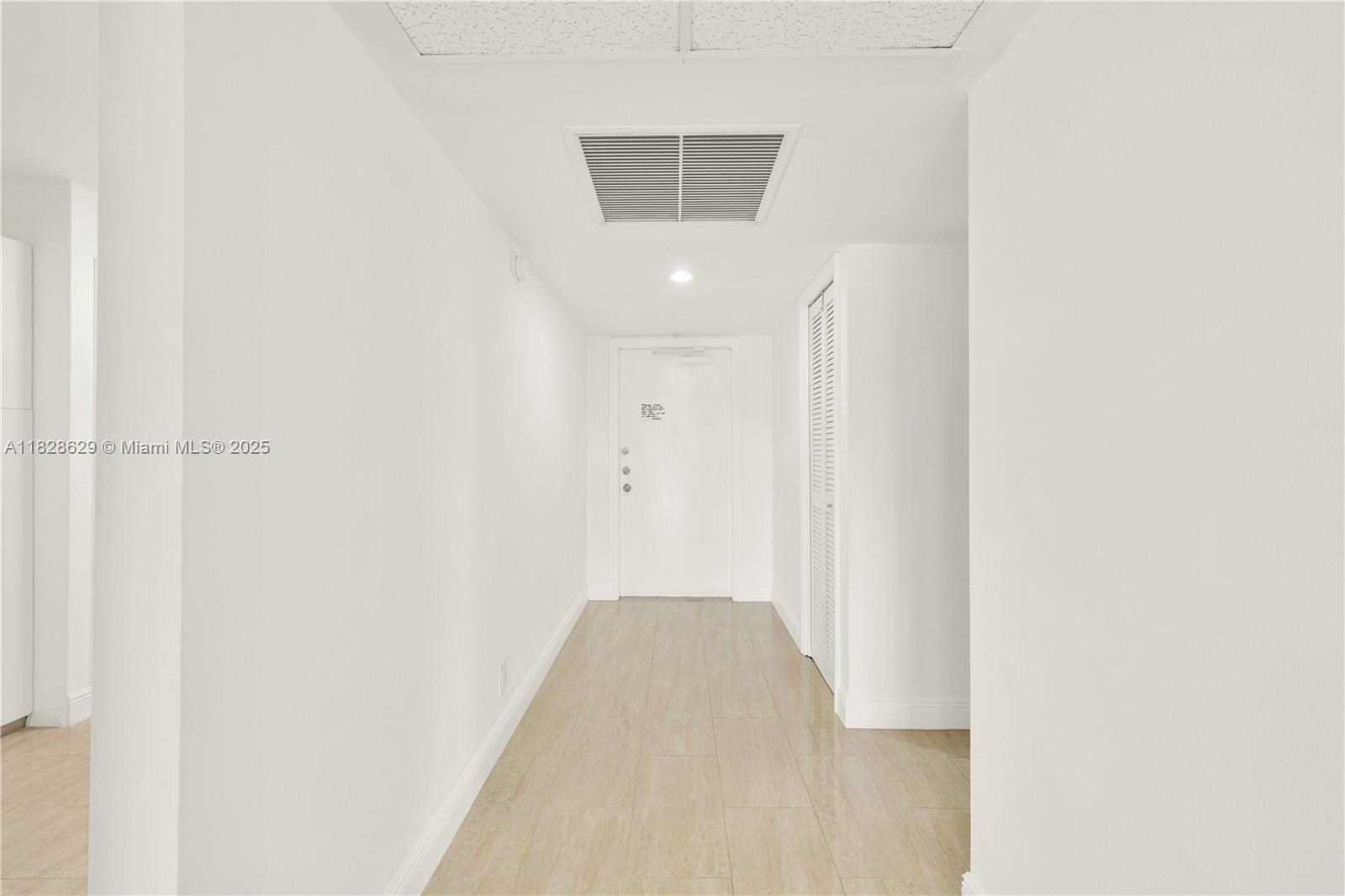 3200 North Course Lane, Unit 216 Pompano Beach, FL 33069 - Photo 21 of 36 a view of a hallway with wooden floor