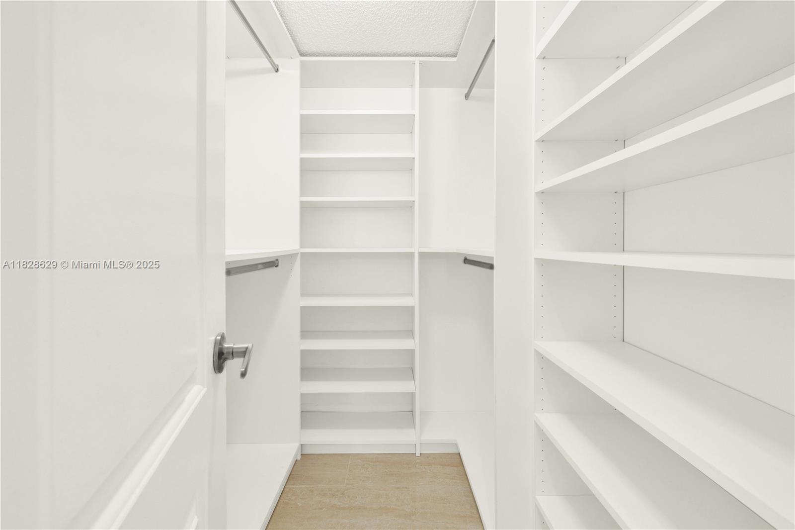 3200 North Course Lane, Unit 216 Pompano Beach, FL 33069 - Photo 23 of 36 a view of walk in closet with empty racks