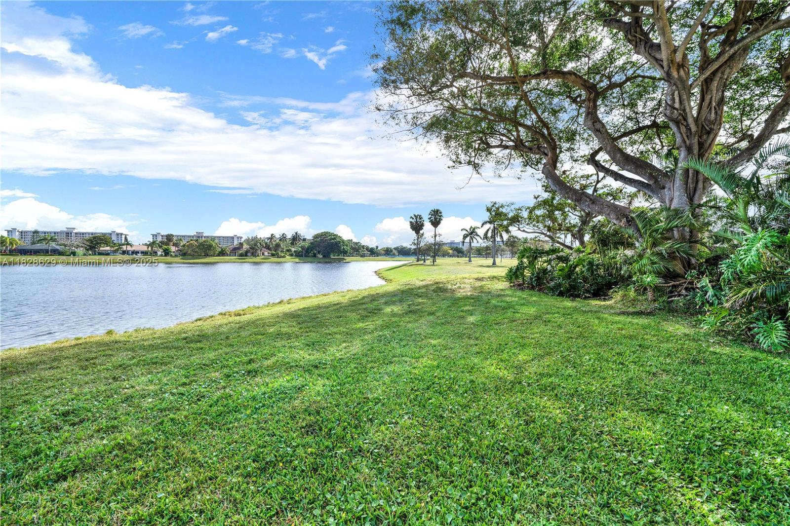 3200 North Course Lane, Unit 216 Pompano Beach, FL 33069 - Photo 29 of 36 a view of a lake with houses in the back