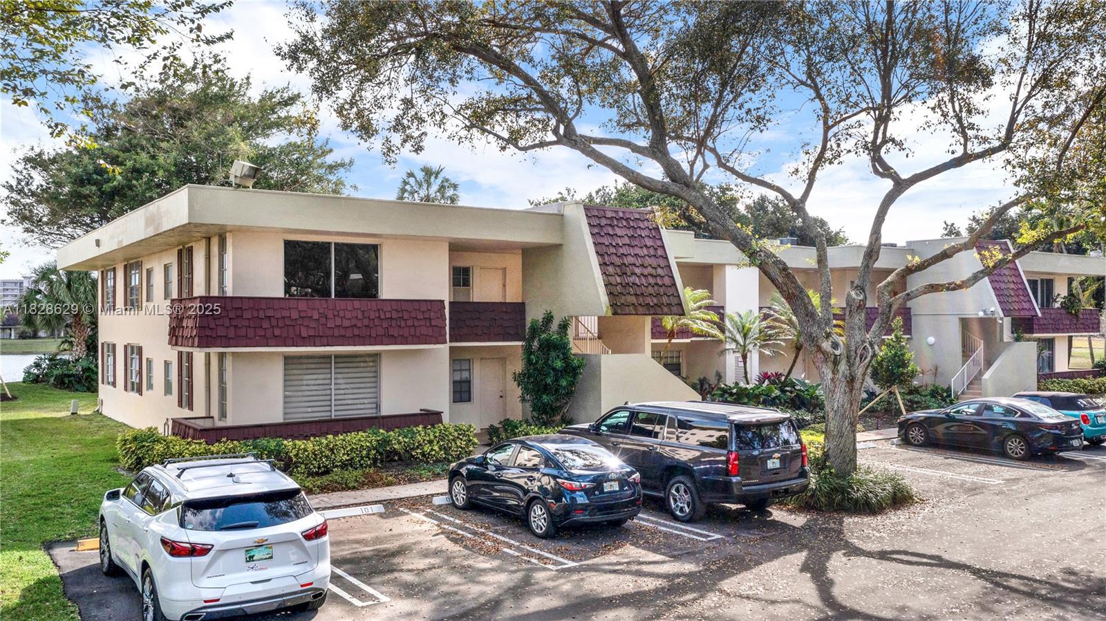 3200 North Course Lane, Unit 216 Pompano Beach, FL 33069 - Photo 4 of 36 a front view of a house with cars parked