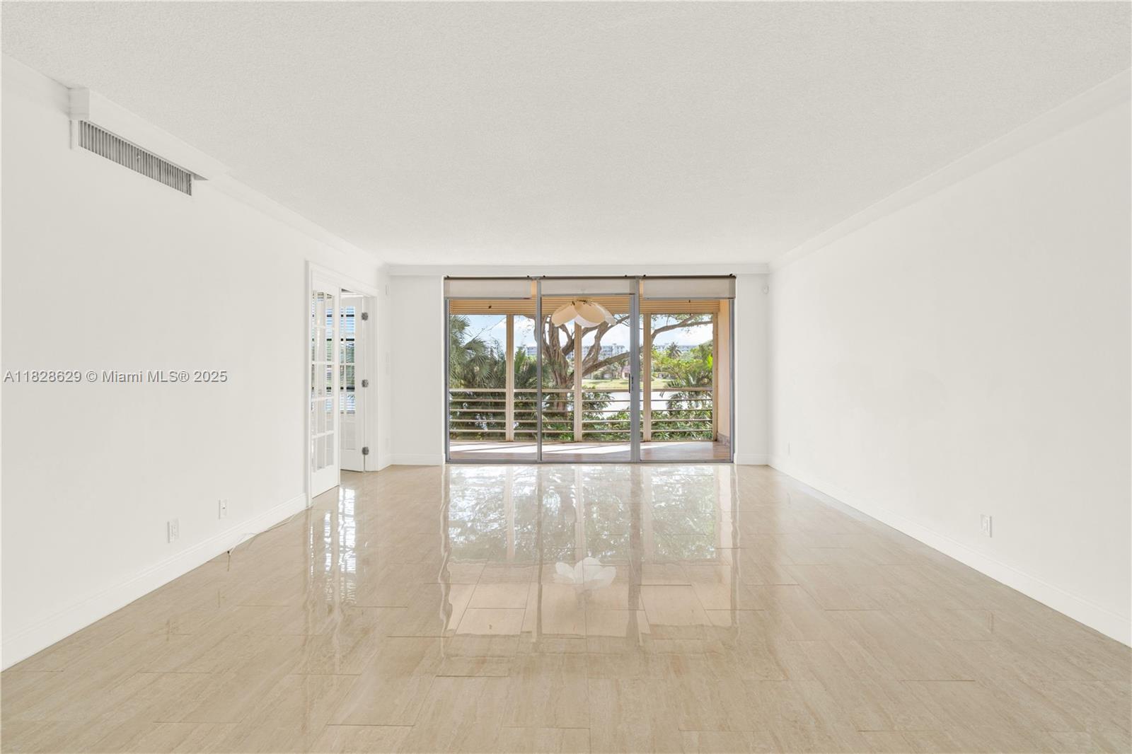 3200 North Course Lane, Unit 216 Pompano Beach, FL 33069 - Photo 9 of 36 a view of an empty room with a window