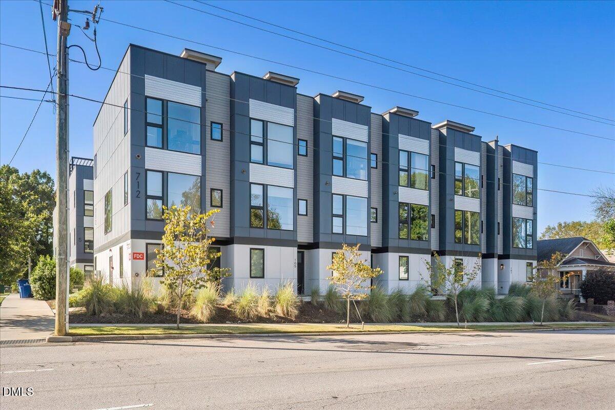 712 East Edenton Street, Unit 102 Raleigh, NC 27601 - Photo 1 of 29 a front view of a building with a garden