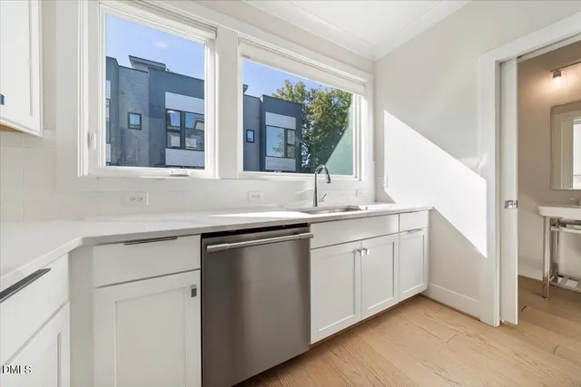 a kitchen with granite countertop white cabinets and white appliances