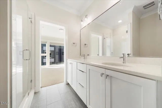 a bathroom with a double vanity sink and mirror