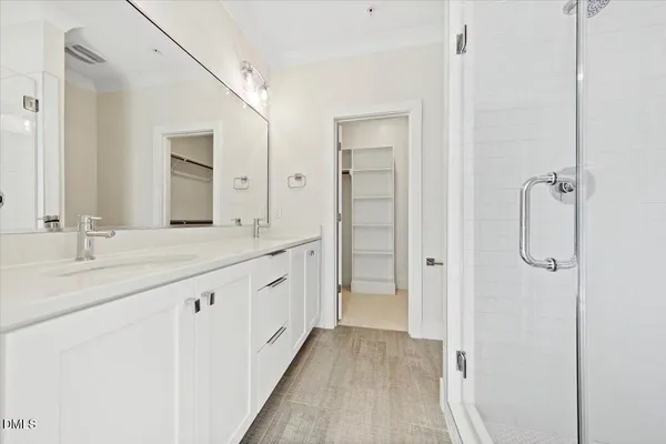 a bathroom with a double vanity sink and mirror