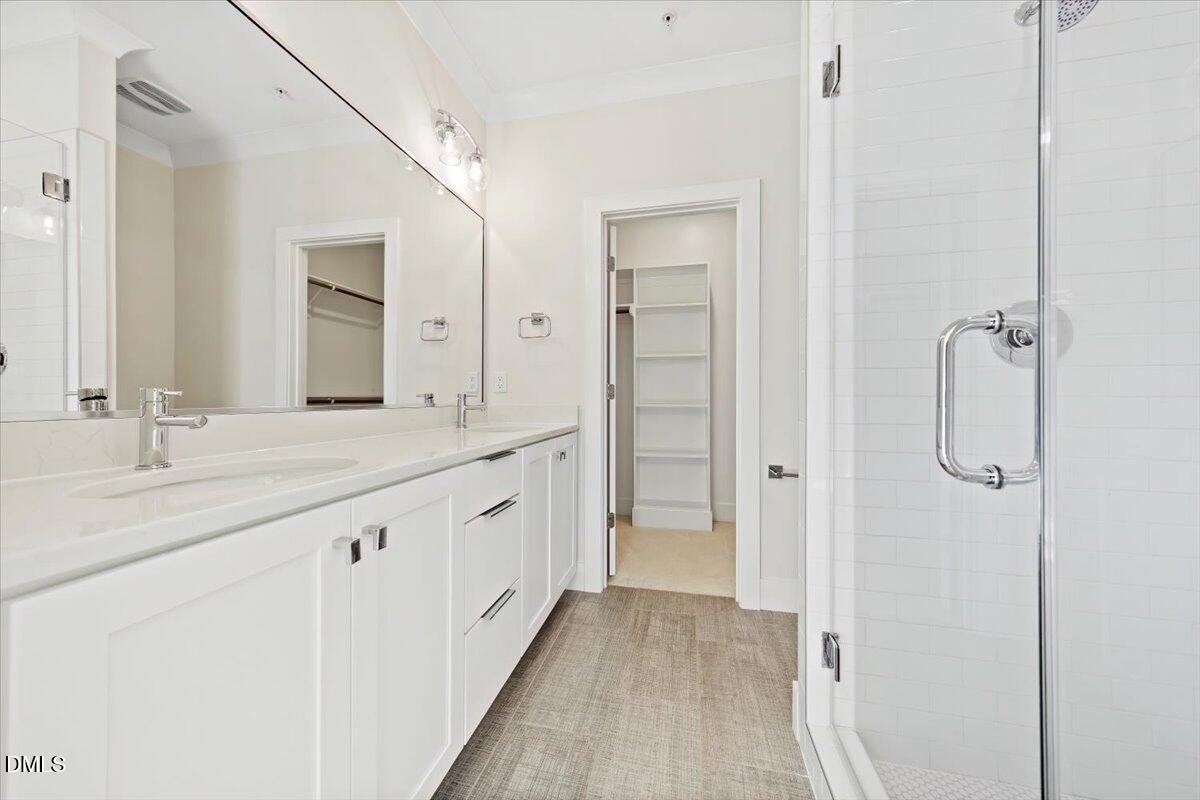 712 East Edenton Street, Unit 102 Raleigh, NC 27601 - Photo 18 of 29 a bathroom with a double vanity sink and mirror