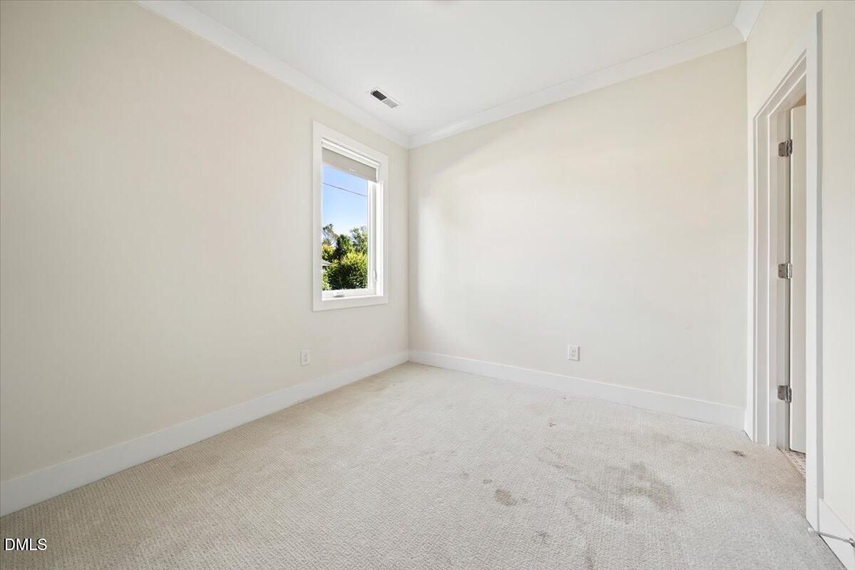 712 East Edenton Street, Unit 102 Raleigh, NC 27601 - Photo 20 of 29 an empty room with windows