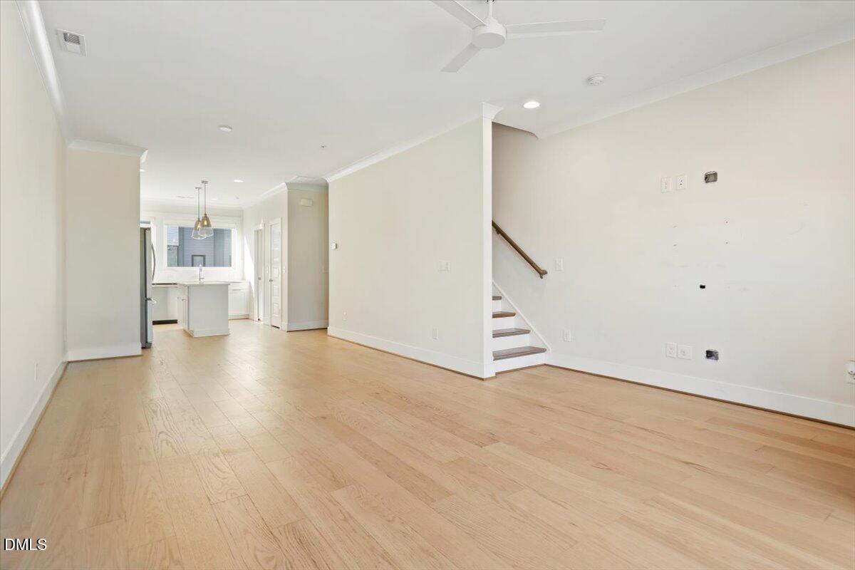 712 East Edenton Street, Unit 102 Raleigh, NC 27601 - Photo 8 of 29 a view of a kitchen with a sink and a refrigerator