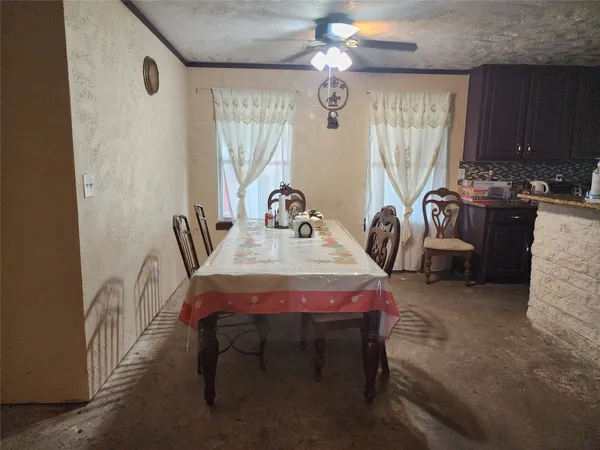 a dining room with furniture and window
