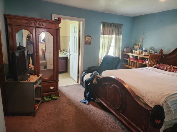 a bedroom with two beds and windows