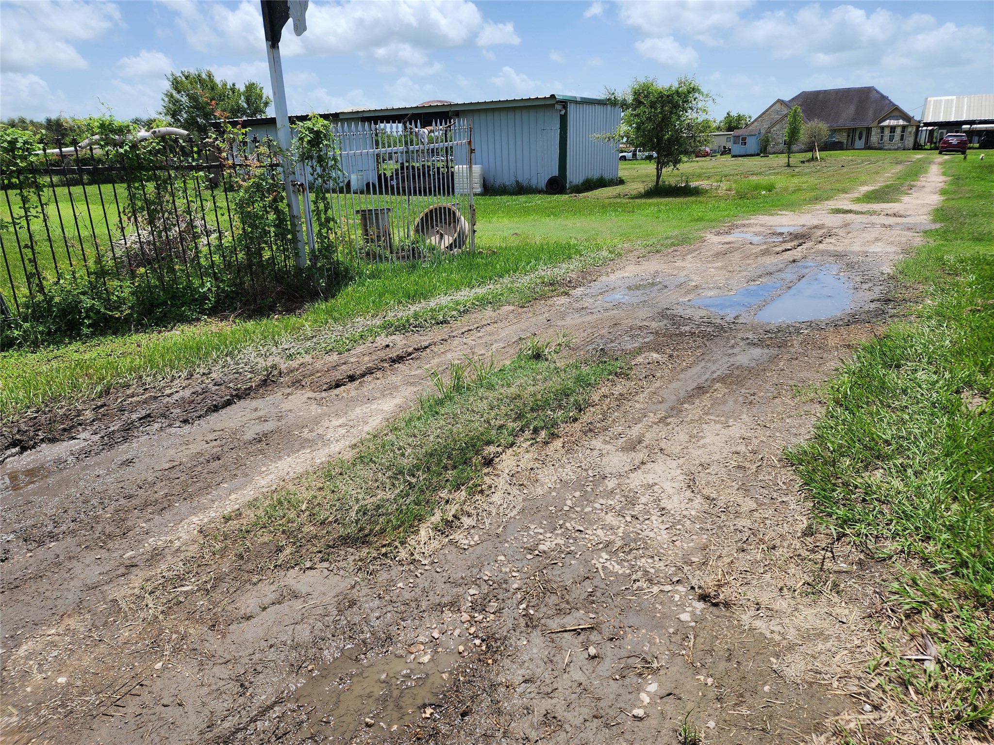 6815 Beard Road Needville, TX 77461 - Photo 2 of 30 a view of a garden with a house in the background