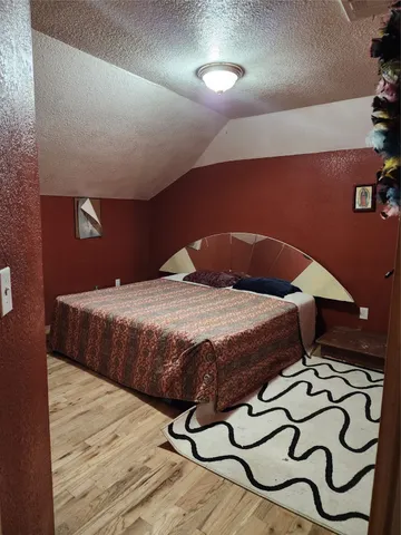 a bedroom with a bed and a night stand