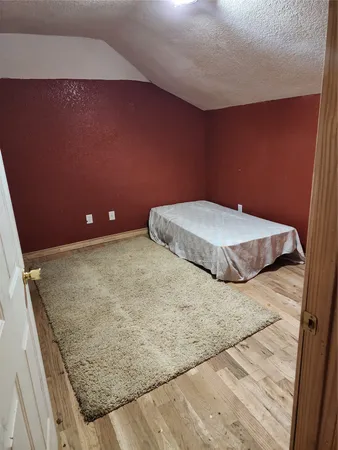 a backyard of a house with plants and large trees