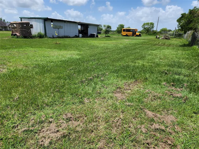 a view of a field of grass and trees