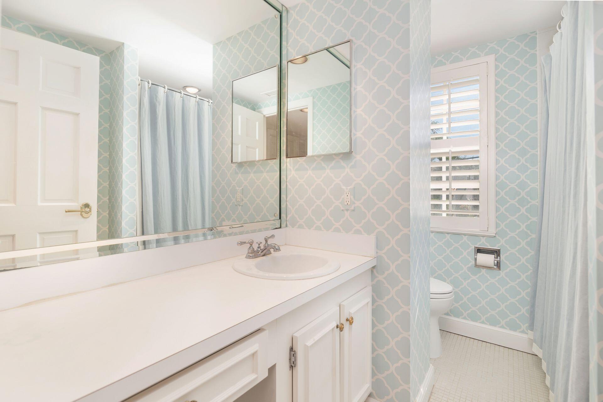 330 Cocoanut Row, Unit 1B Palm Beach, FL 33480 - Photo 14 of 18 a bathroom with a sink and a mirror