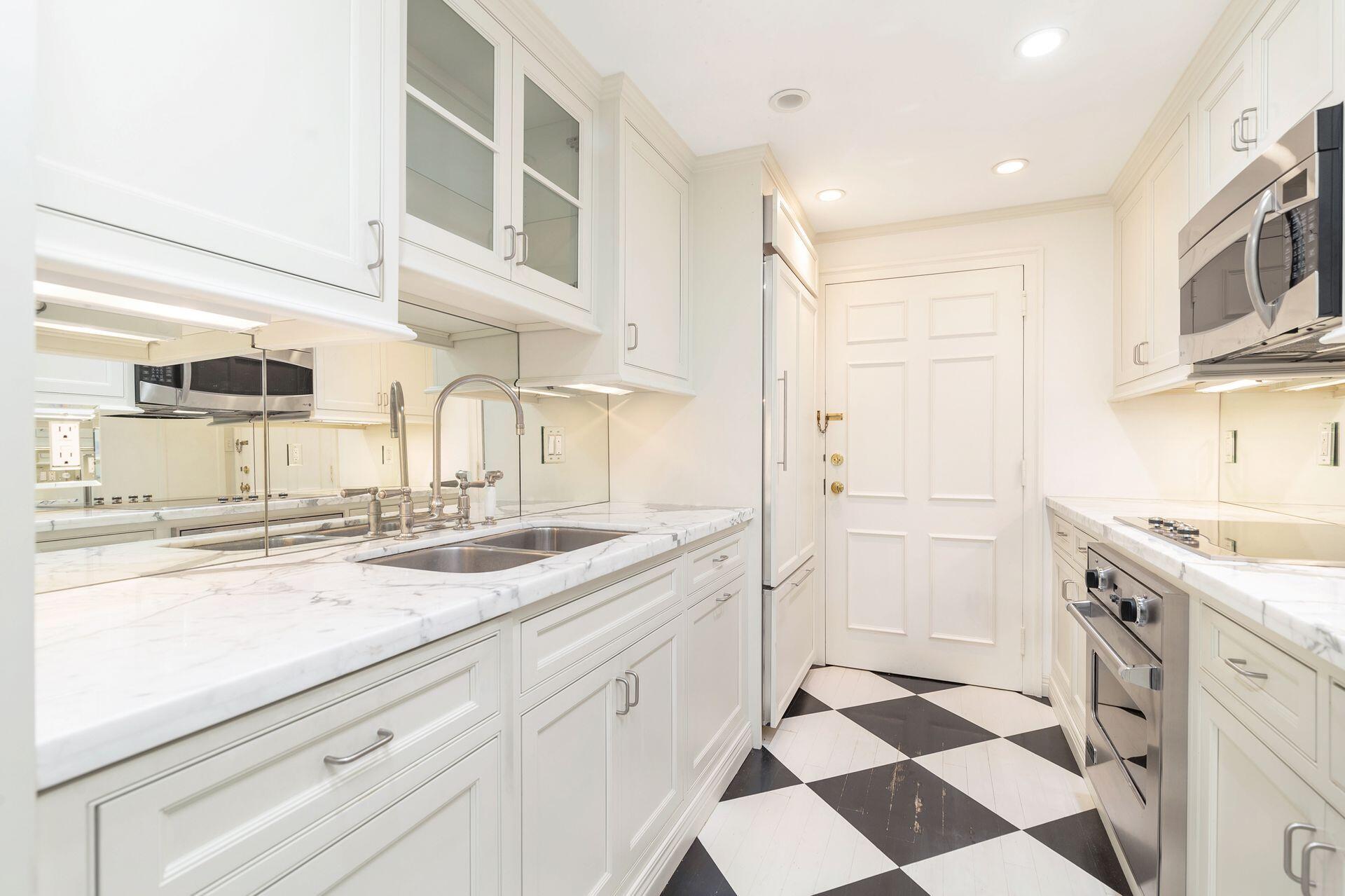 330 Cocoanut Row, Unit 1B Palm Beach, FL 33480 - Photo 8 of 18 a kitchen with a sink a stove and cabinets