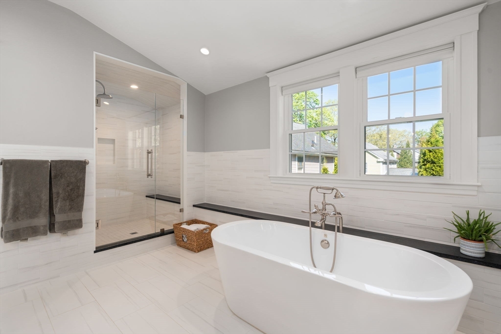 59 Avon Road Wellesley, MA 02482 - Photo 24 of 39 a white bath tub sitting in a en suite bathroom next to a window