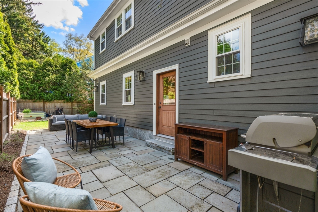 59 Avon Road Wellesley, MA 02482 - Photo 35 of 39 a view of a patio with a dining table and chairs