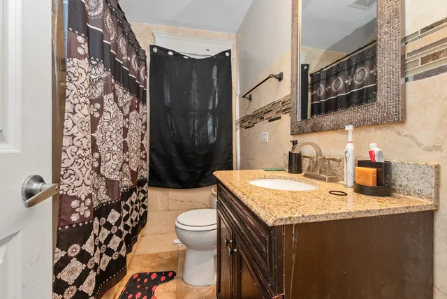 a bathroom with a sink toilet and shower