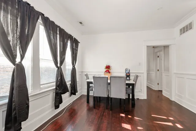 a view of a dining room with furniture and a window