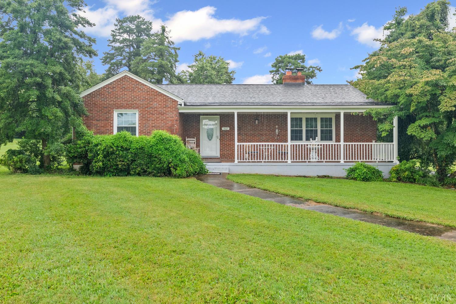 a front view of a house with a yard and porch