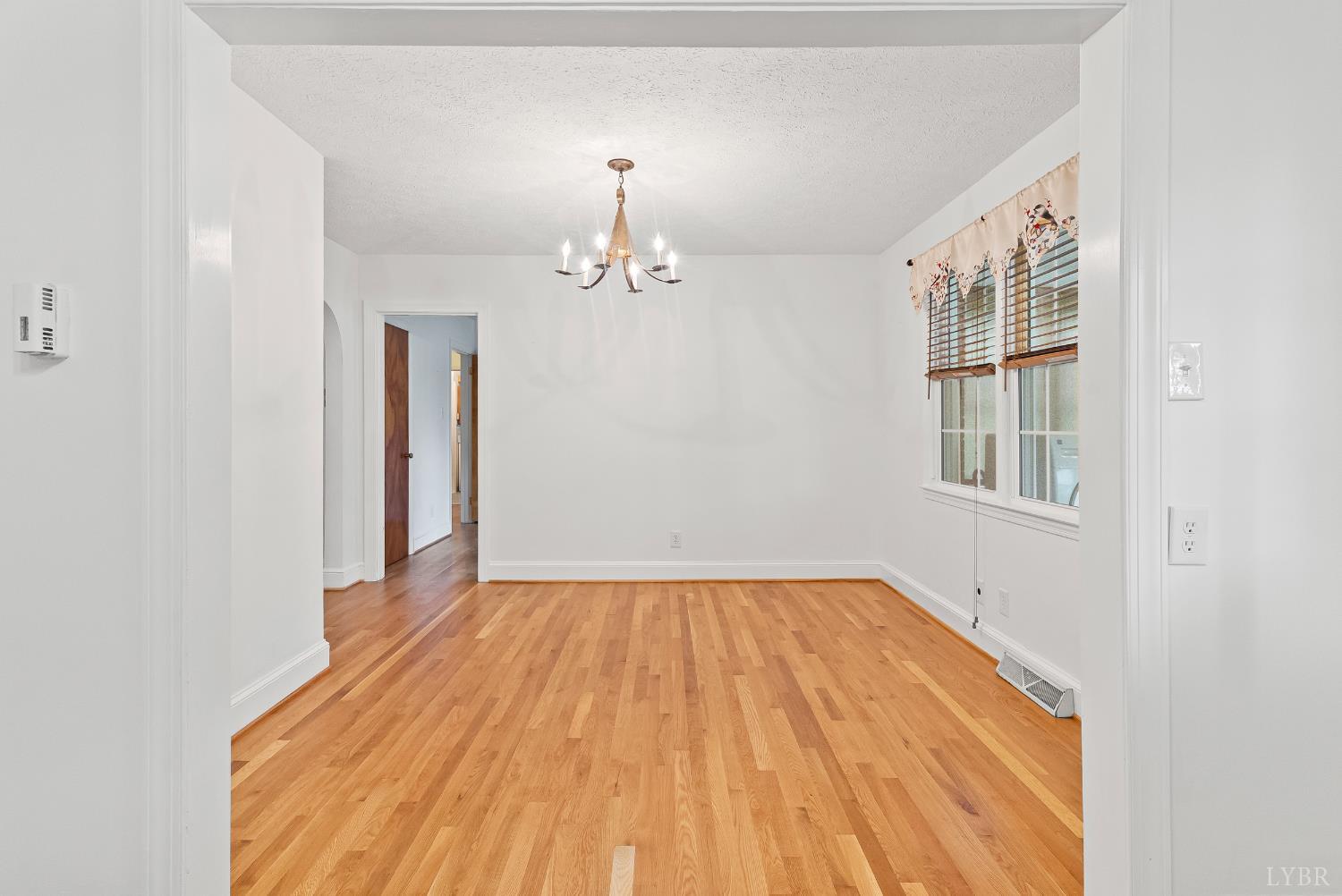 302 Henry Street Gretna, VA 24557 - Photo 12 of 49 a view of empty room with wooden floor and fan