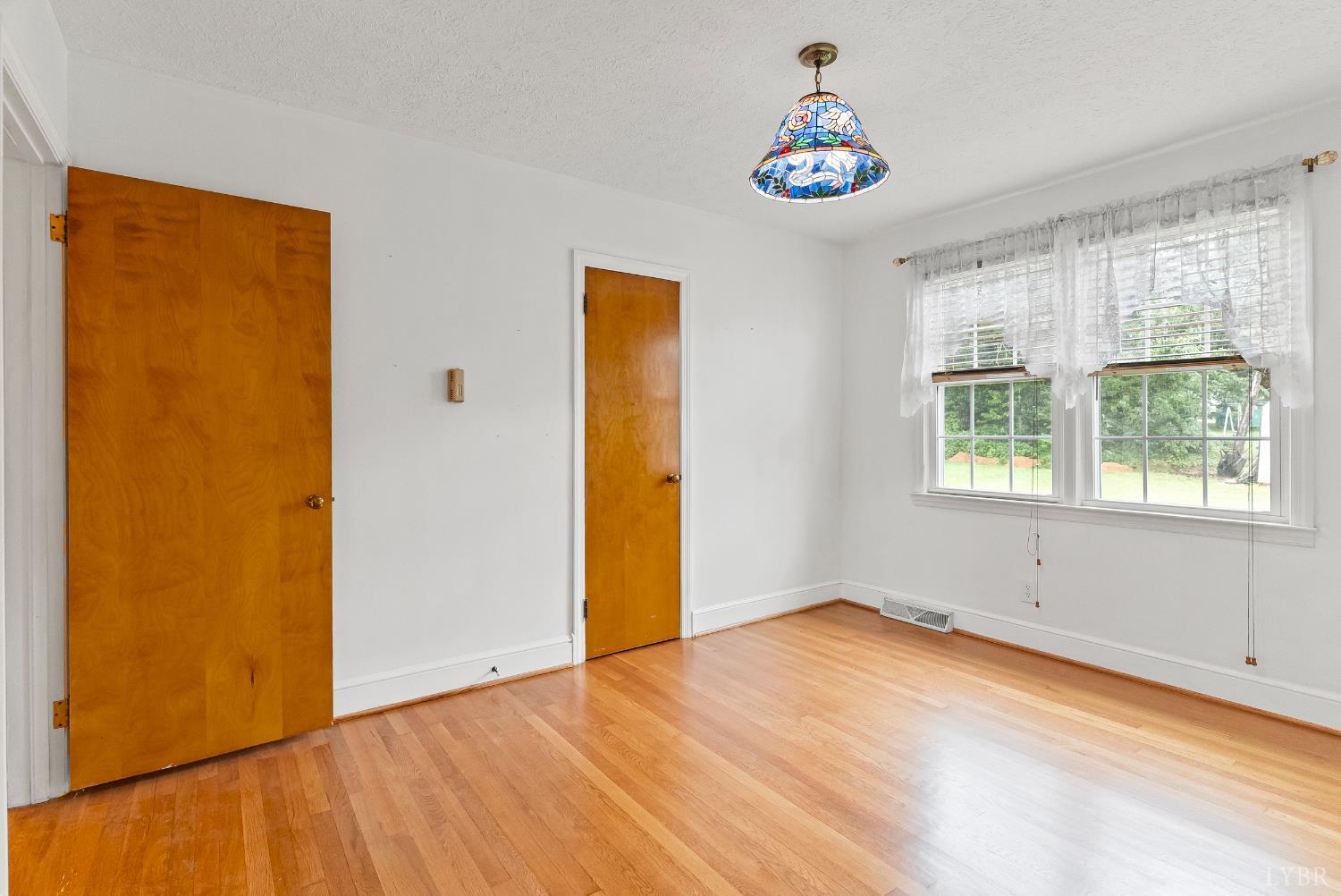 302 Henry Street Gretna, VA 24557 - Photo 13 of 49 wooden floor in an empty room with a window