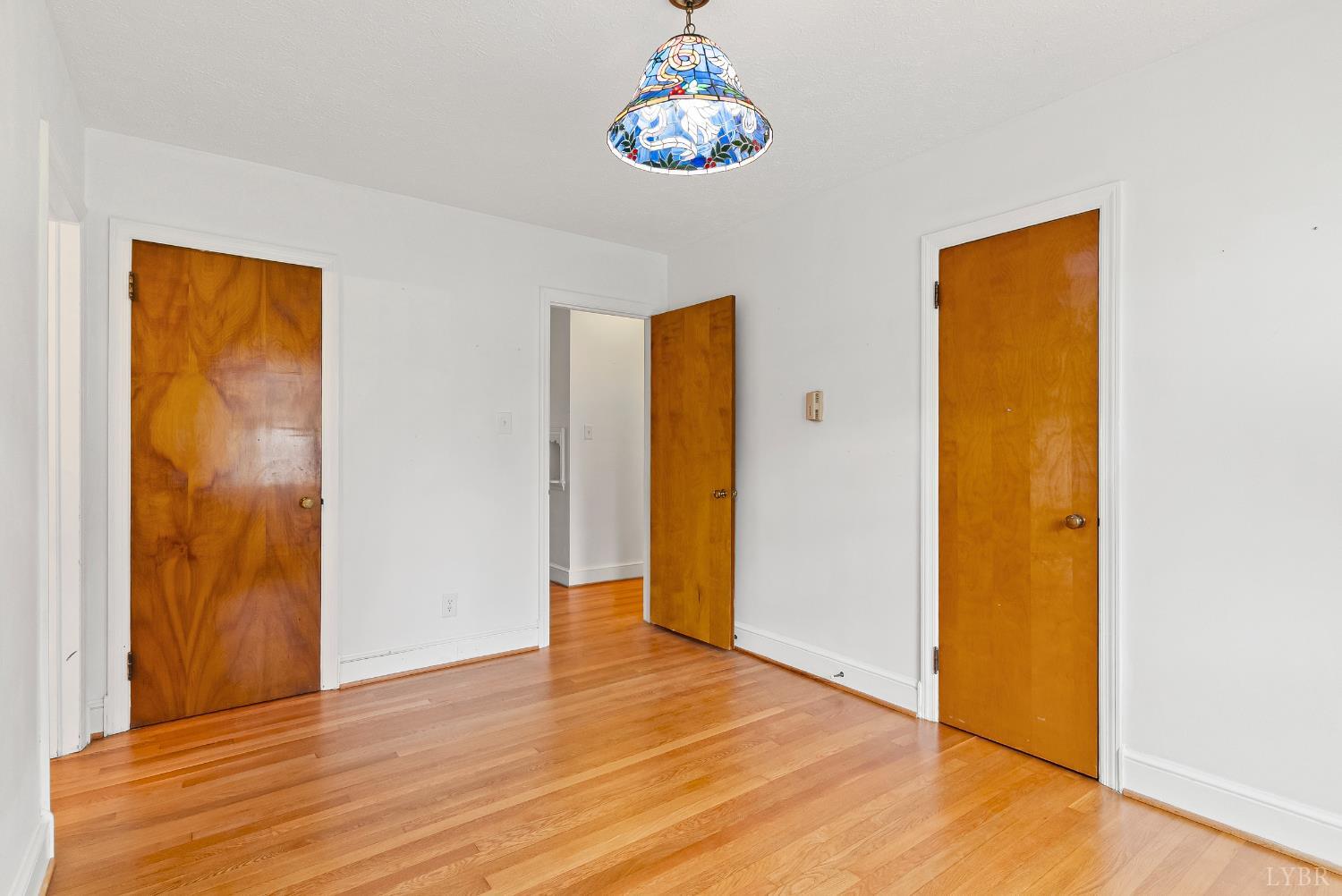 302 Henry Street Gretna, VA 24557 - Photo 14 of 49 a view of an empty room with wooden floor and a window