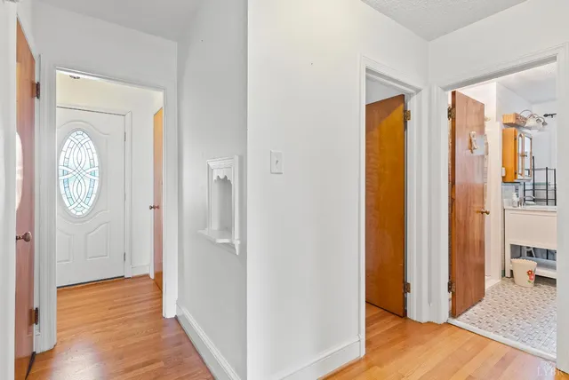 a view of hallway with wooden floor