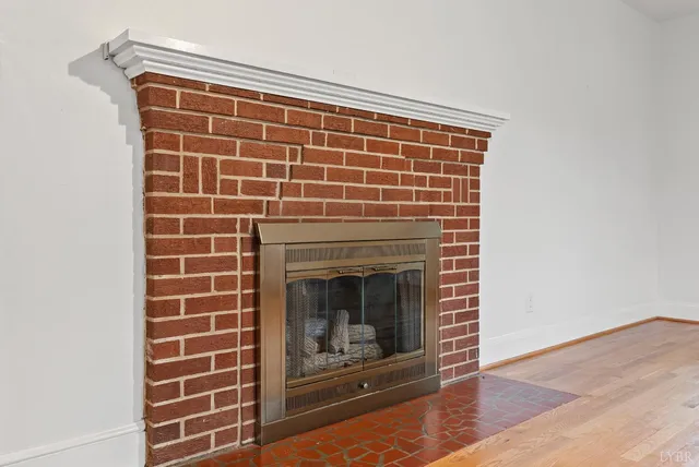 a view of empty room with a fireplace