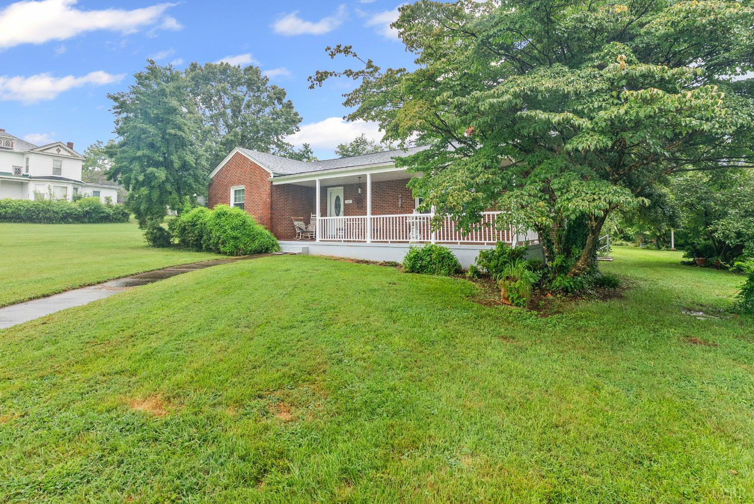 302 Henry Street Gretna, VA 24557 - Photo 33 of 49 a front view of a house with garden