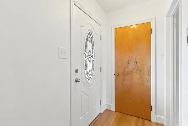 a view of front door with wooden floor