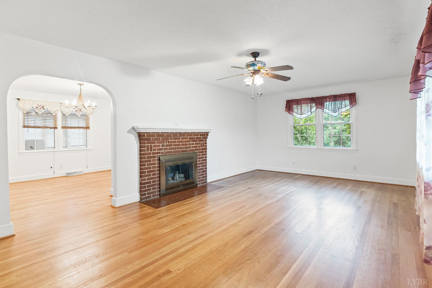 302 Henry Street Gretna, VA 24557 - Photo 7 of 49 a view of an empty room with a window and wooden floor