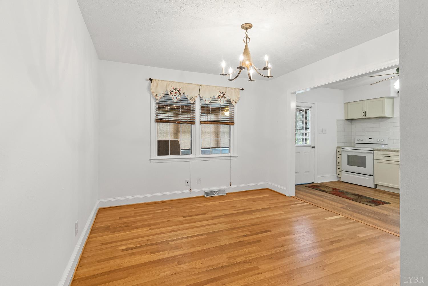 302 Henry Street Gretna, VA 24557 - Photo 9 of 49 a view of an empty room with a window
