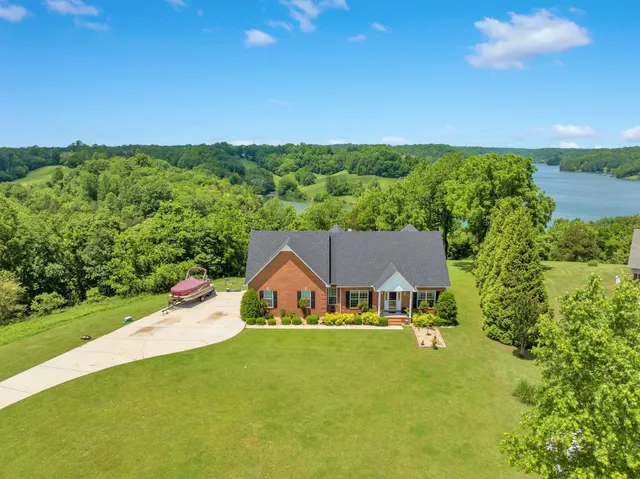 an aerial view of a house with swimming pool and garden