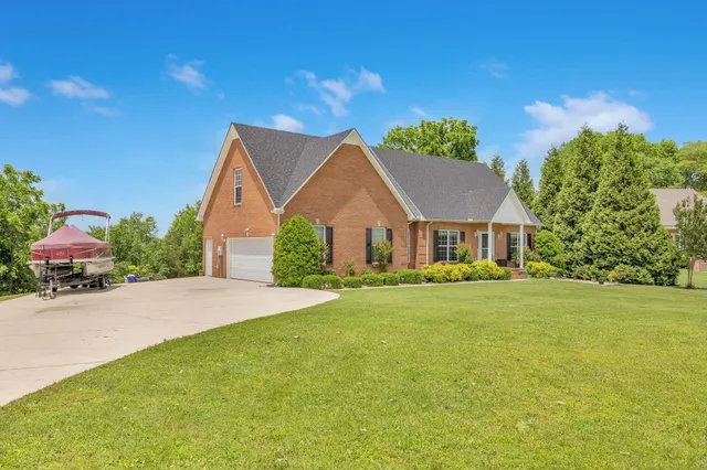 a front view of a house with a yard and garage