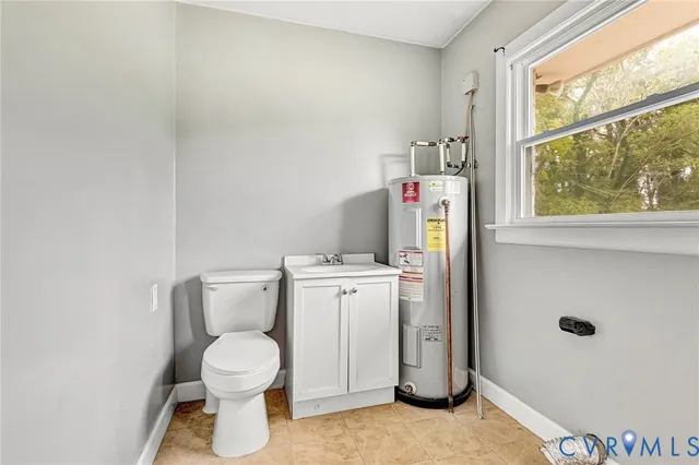 a white toilet sitting next to a bathroom sink