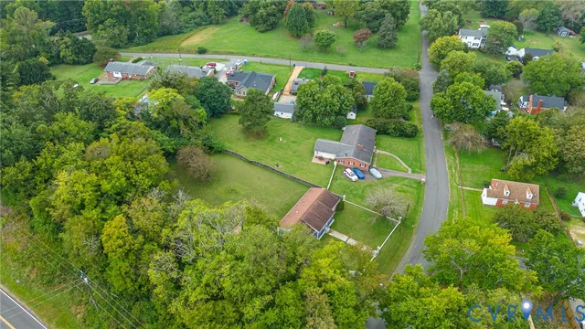 an aerial view of a house with pool outdoor seating and yard
