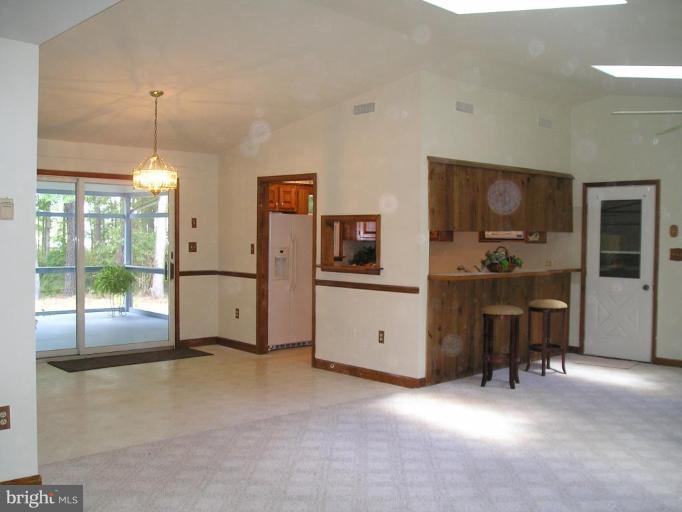 7850 Pea Neck Road St. Michaels, MD 21663 - Photo 3 of 5 a view of a livingroom with furniture and windows