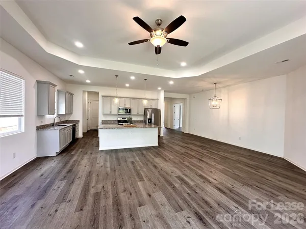a view of kitchen with refrigerator microwave and stove