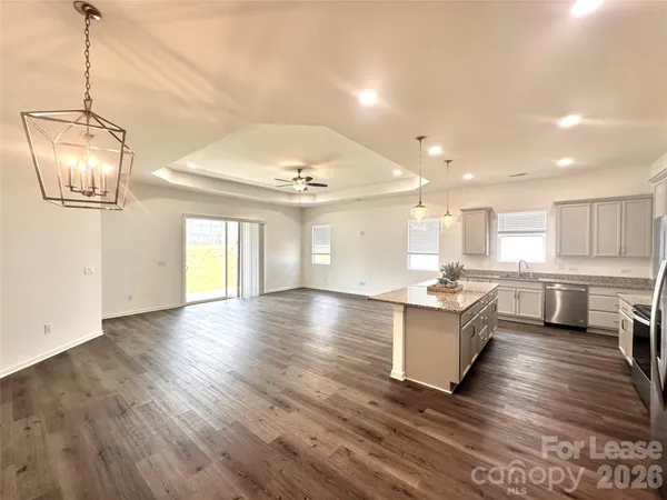 a kitchen with stainless steel appliances granite countertop a stove and cabinets