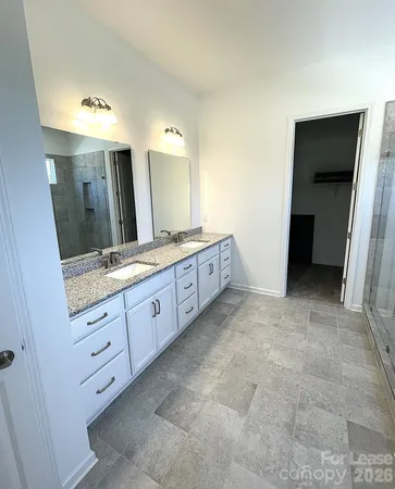 a spacious bathroom with a granite countertop sink mirror and a