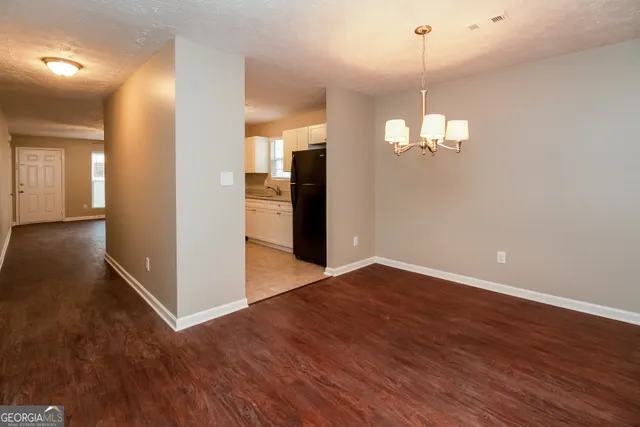 a view of a chandelier in a room with wooden floor
