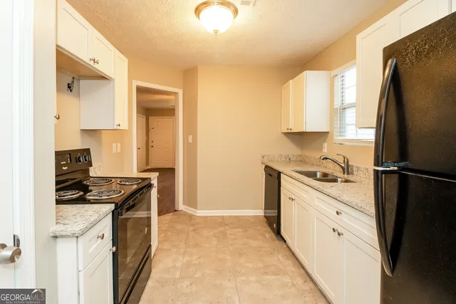 a kitchen with stainless steel appliances a refrigerator sink and stove