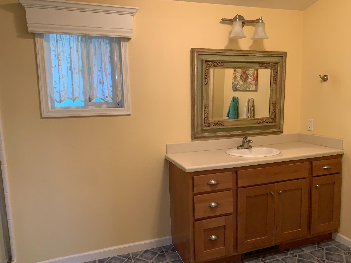 270 Hames Road, Unit 55 Watsonville, CA 95076 - Photo 30 of 53 a bathroom with a sink a vanity and a mirror