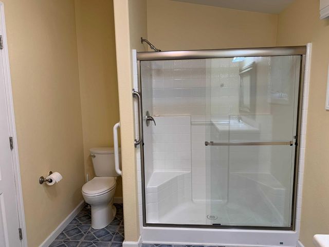 a bathroom with a glass shower door