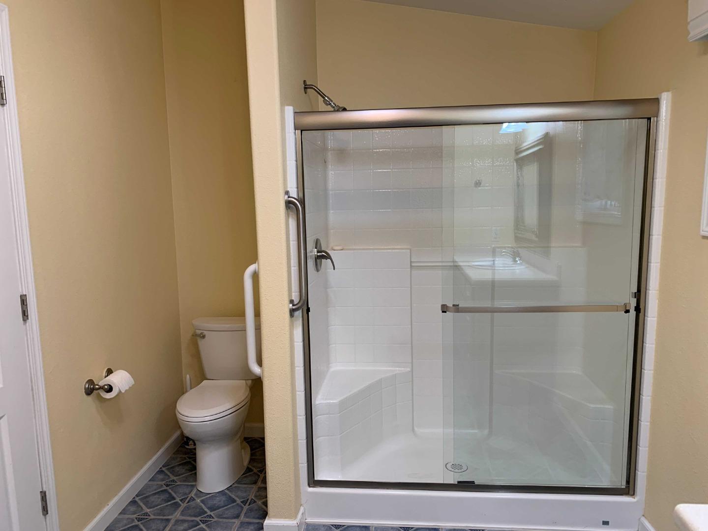 270 Hames Road, Unit 55 Watsonville, CA 95076 - Photo 31 of 53 a bathroom with a glass shower door