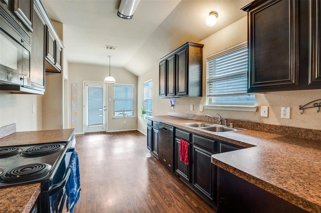 4040 Golden Rod Drive Forney, TX 75126 - Photo 11 of 25 a kitchen with granite countertop a stove and a sink